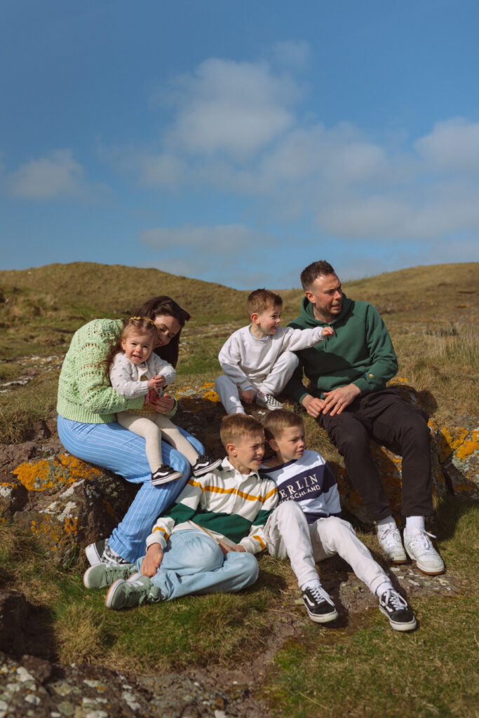 family photoshoot experience Scotland gathered together looking out to sea