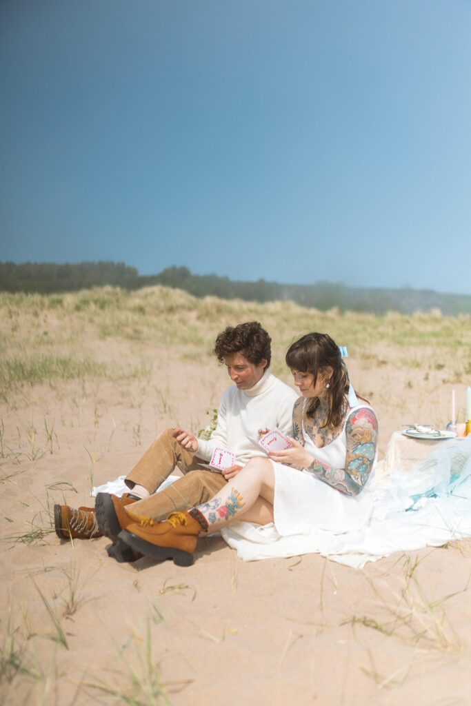 couple writes vows to each other on their elopement day on the beach at st cyrus in scotland