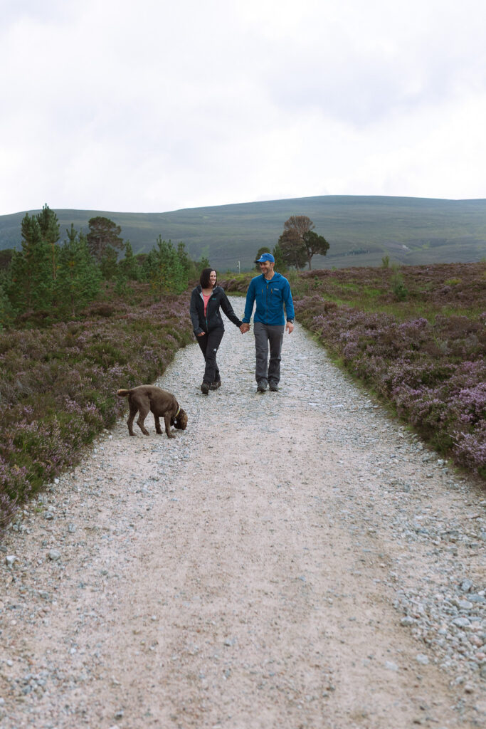Relaxed hiking couple laughing together in the Scottish mountains