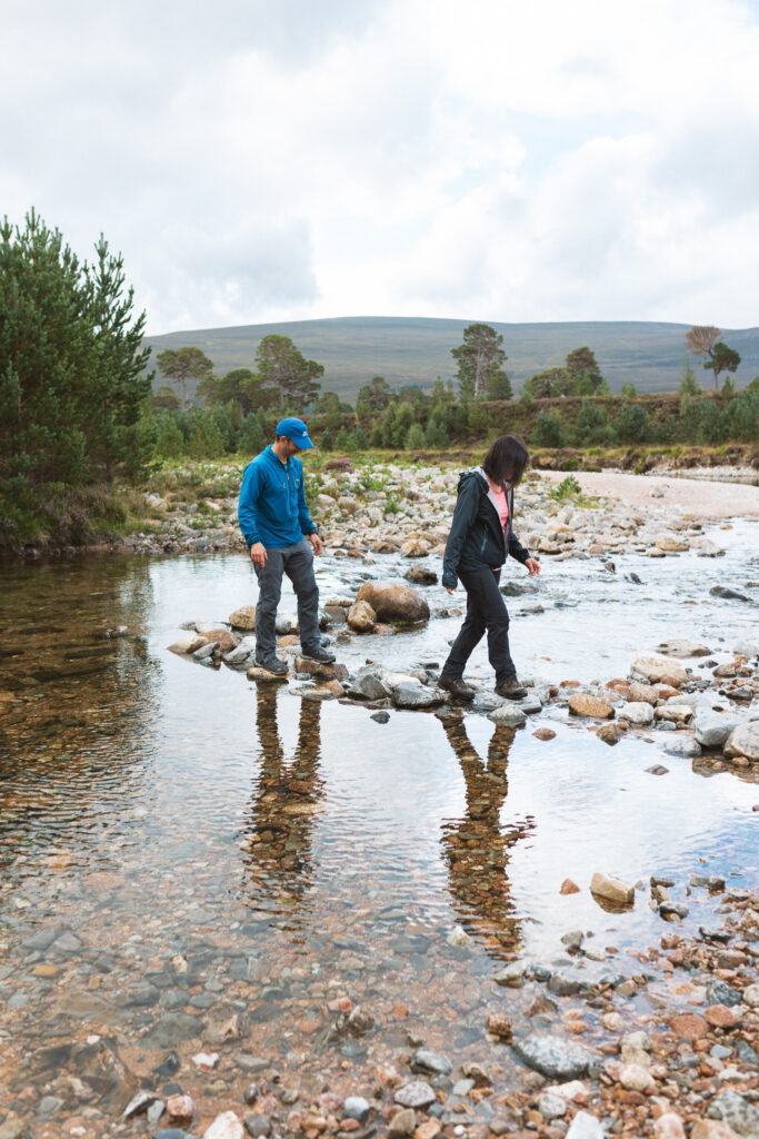 Adventurous couple embracing the wild Cairngorms hillside